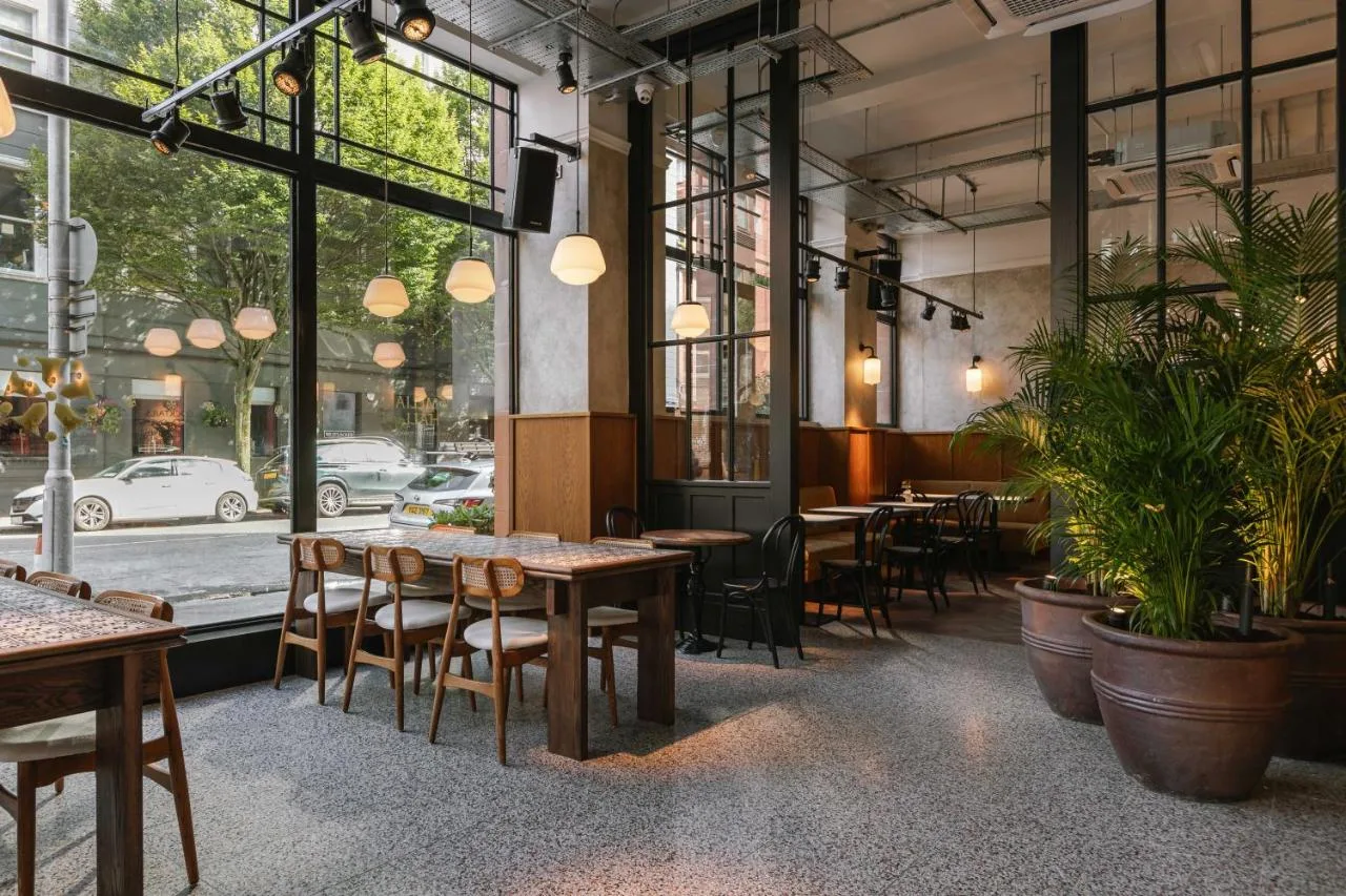 Restaurant seating area with plants at The Flint Hotel on Howard Street, Belfast