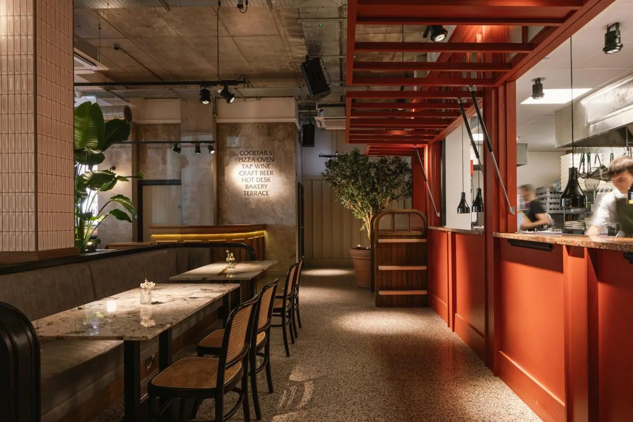 Red-walled restaurant dining area at The Flint Hotel, Belfast