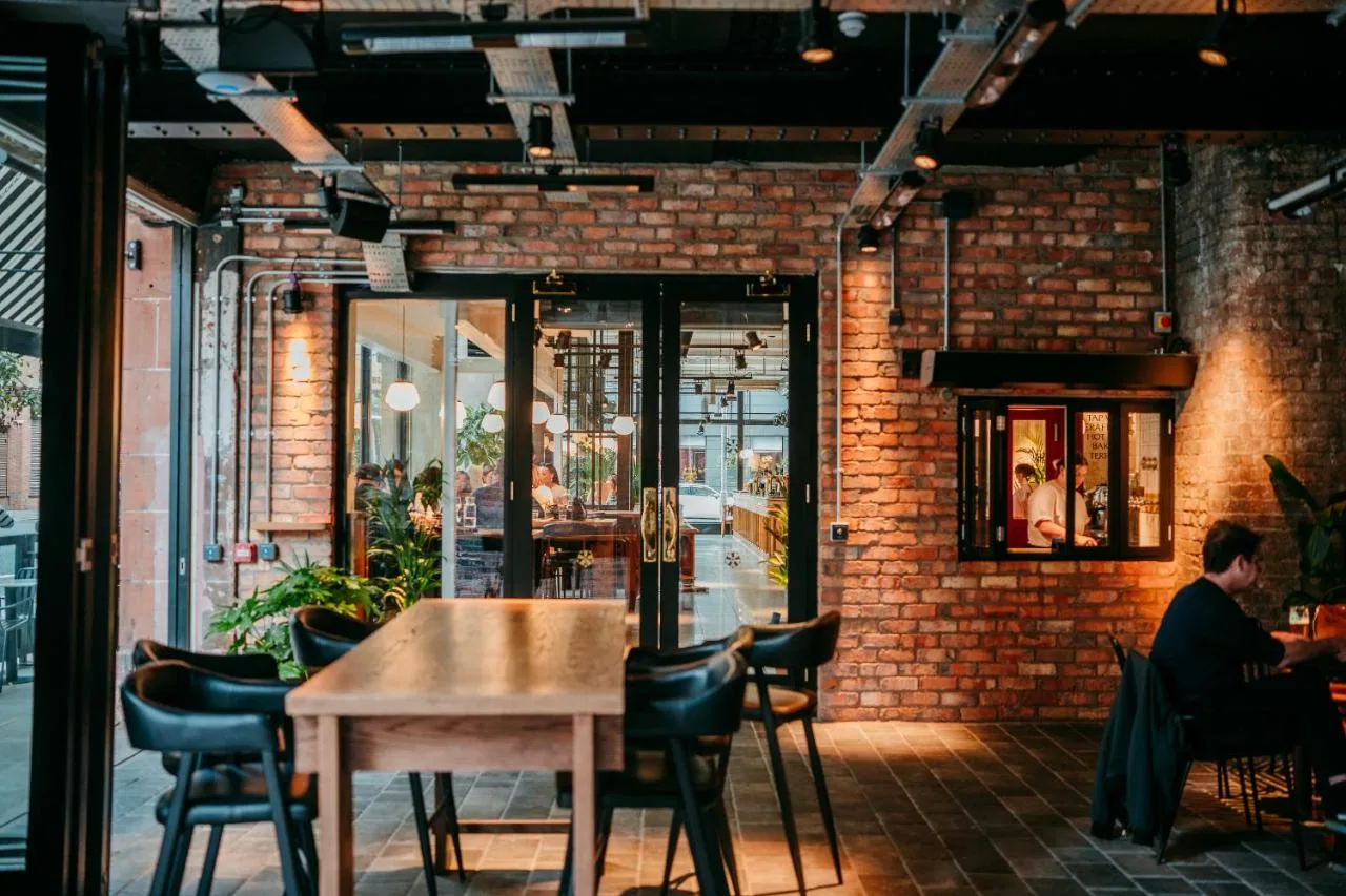 Guest seated at a table in The Flint Hotel restaurant, Belfast city centre