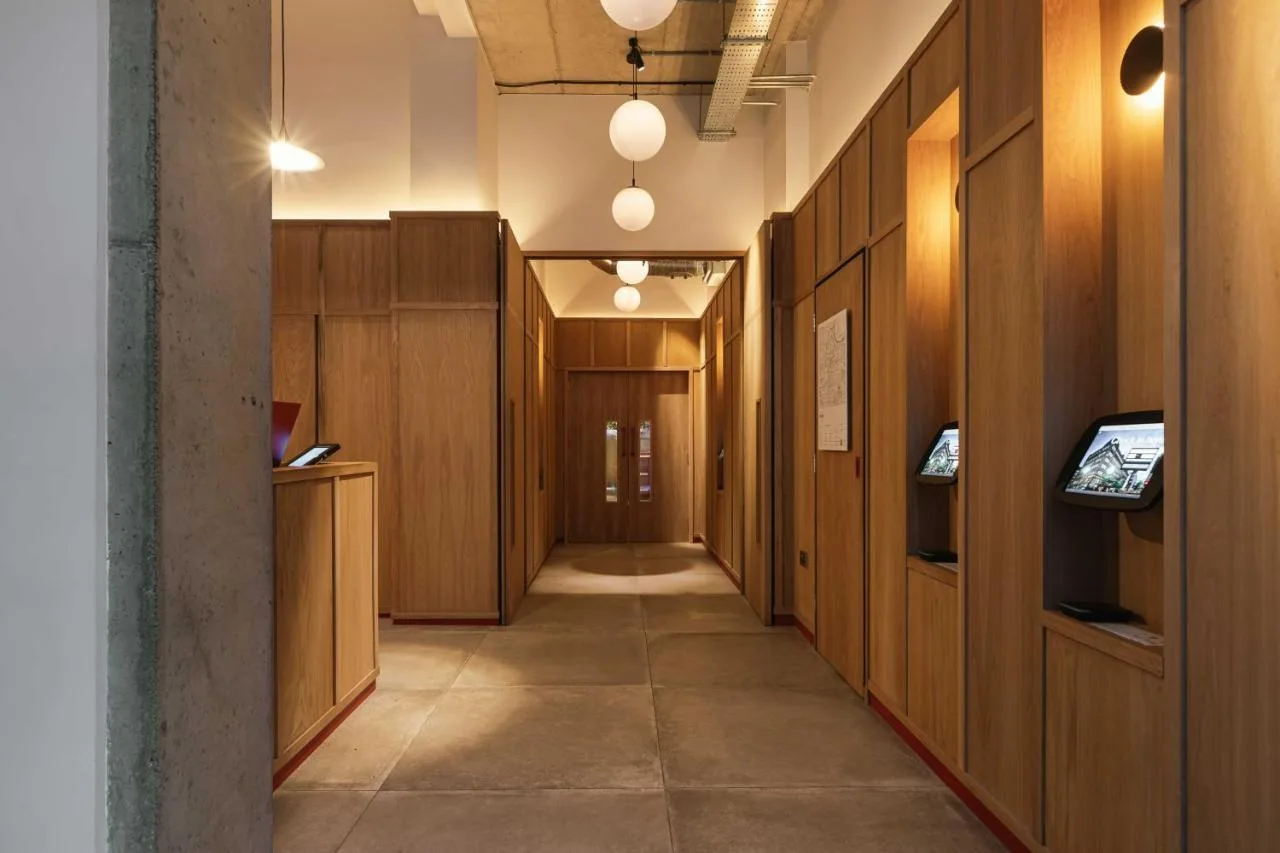 Wood-panelled hallway leading to studio rooms at The Flint Hotel, Belfast
